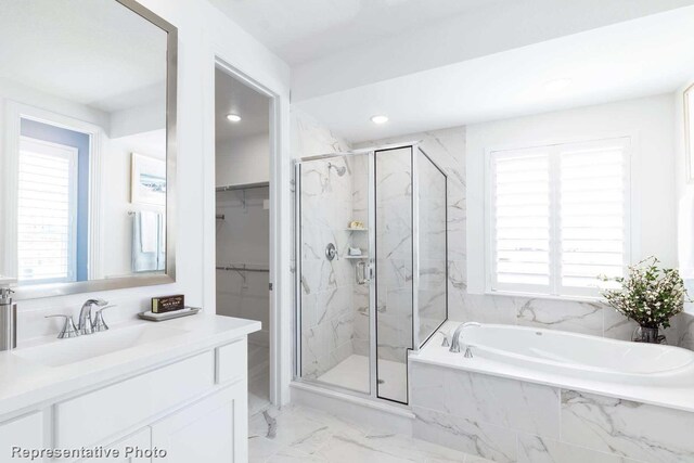 bathroom featuring separate shower and tub and vanity