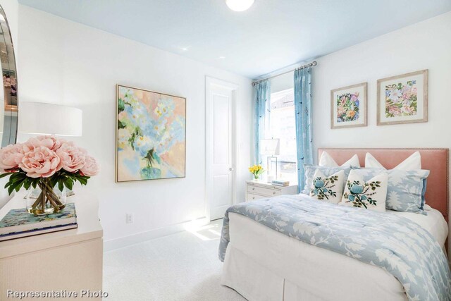 bedroom featuring light colored carpet