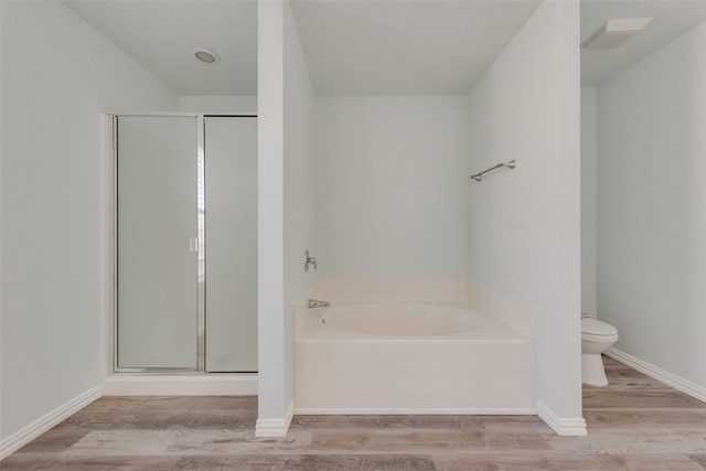 bathroom with hardwood / wood-style floors, toilet, and independent shower and bath