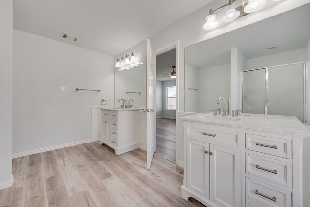 bathroom featuring walk in shower, vanity, hardwood / wood-style floors, and ceiling fan