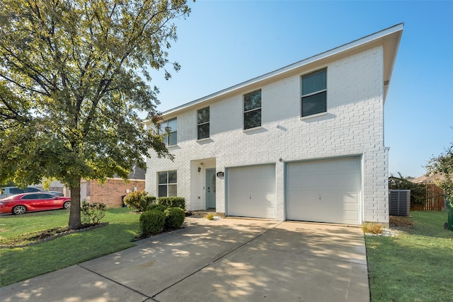 view of front of home with a front yard, cooling unit, and a garage