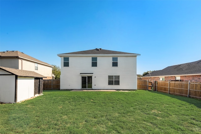 rear view of house with a storage shed, a lawn, and a patio area