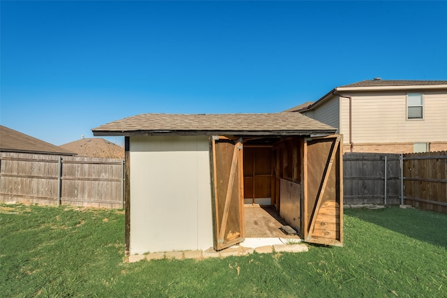 view of outbuilding featuring a lawn