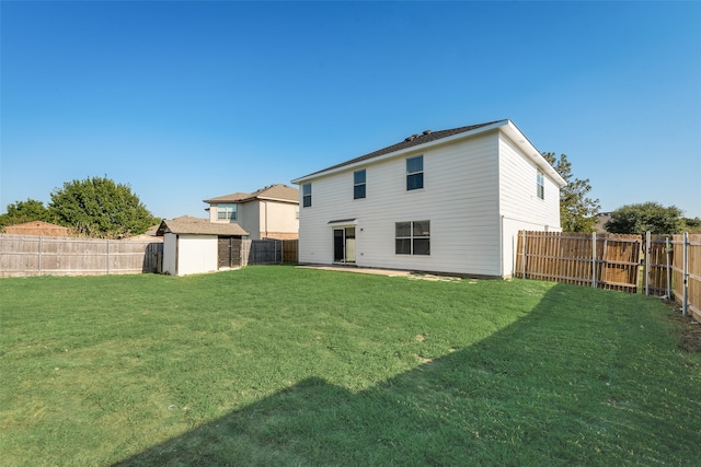 back of property featuring a storage shed and a lawn