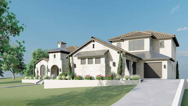 mediterranean / spanish home featuring a front yard and a garage