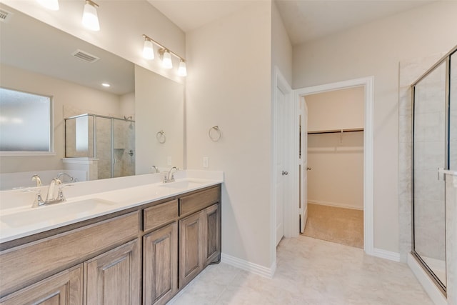 bathroom featuring vanity and a shower with door