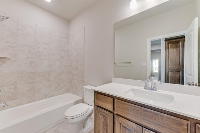 full bathroom featuring toilet, vanity, and tiled shower / bath