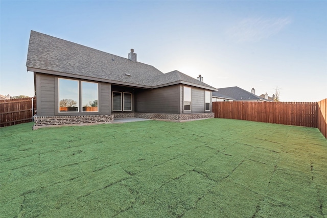 rear view of house featuring a lawn