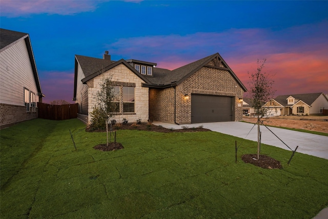 view of front facade with a garage and a yard