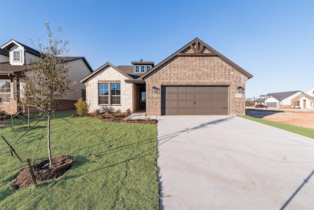 view of front of home with a front yard and a garage