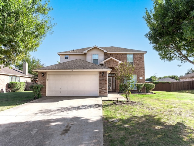 view of front property featuring a front lawn and a garage