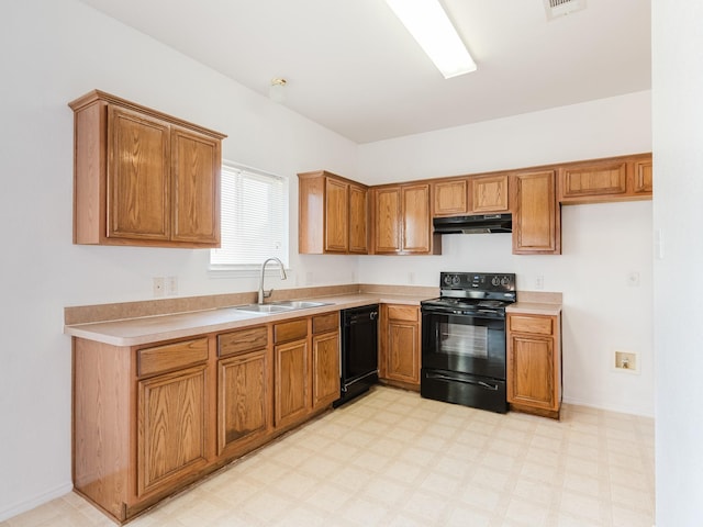 kitchen with a sink, light countertops, under cabinet range hood, brown cabinetry, and black appliances