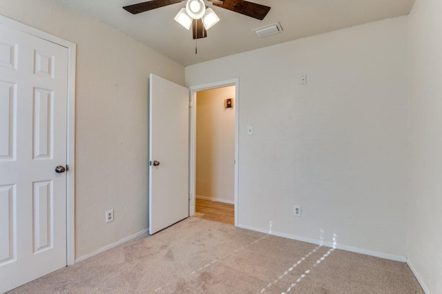 unfurnished bedroom with ceiling fan and light carpet