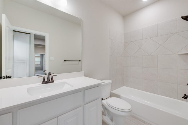 full bathroom featuring toilet, vanity, and tiled shower / bath combo