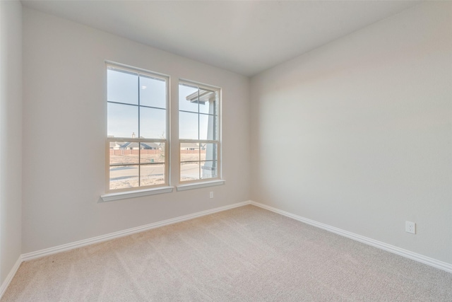 unfurnished room with light colored carpet