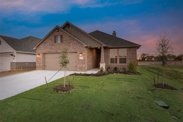 view of front of property featuring a garage and a yard