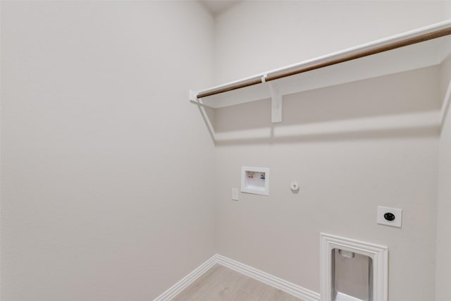 laundry area with hookup for an electric dryer, hookup for a washing machine, gas dryer hookup, and hardwood / wood-style flooring