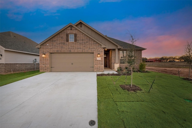 view of front of property with a garage and a lawn