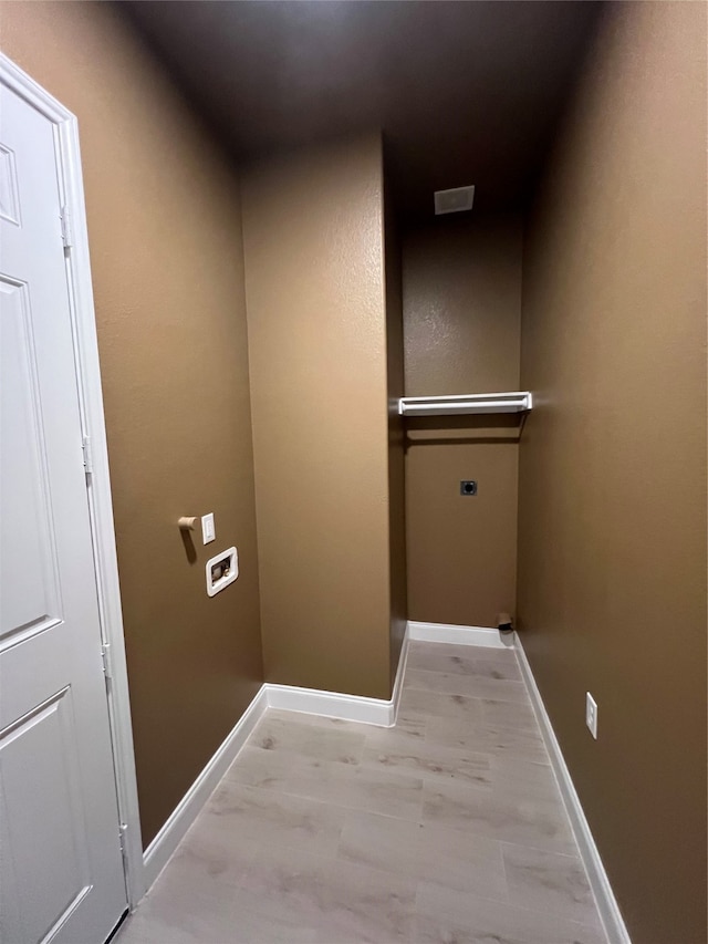 laundry room featuring light hardwood / wood-style flooring and hookup for an electric dryer