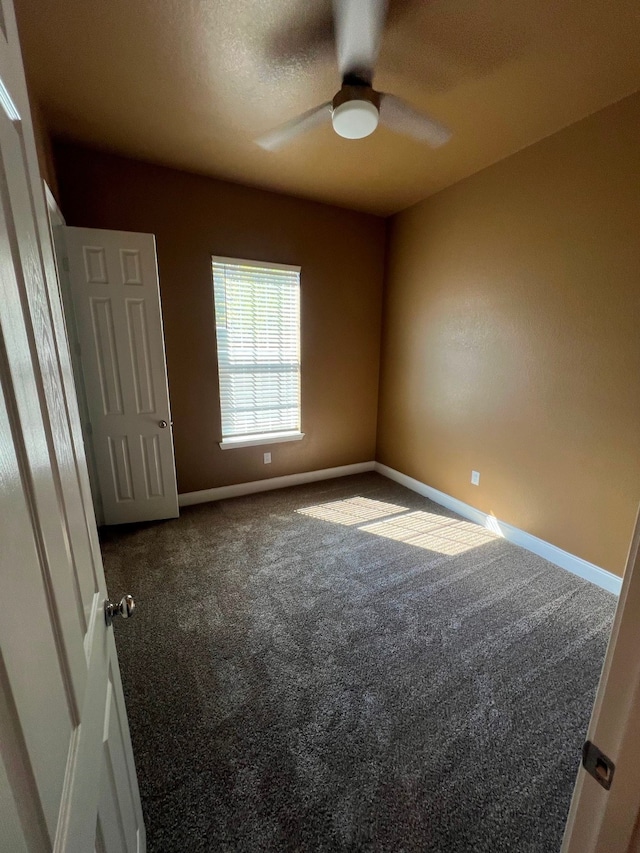 carpeted empty room with a textured ceiling and ceiling fan