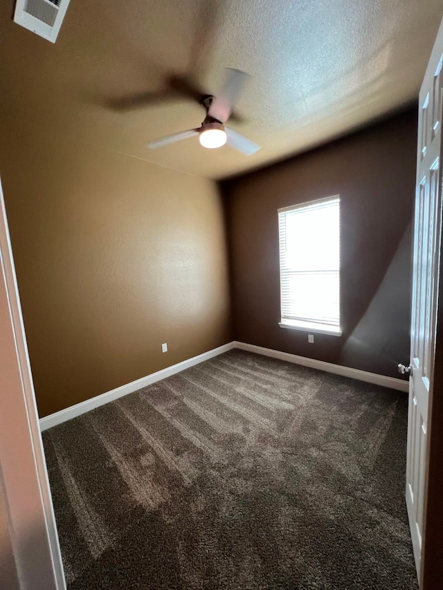 empty room with a textured ceiling, ceiling fan, and carpet flooring