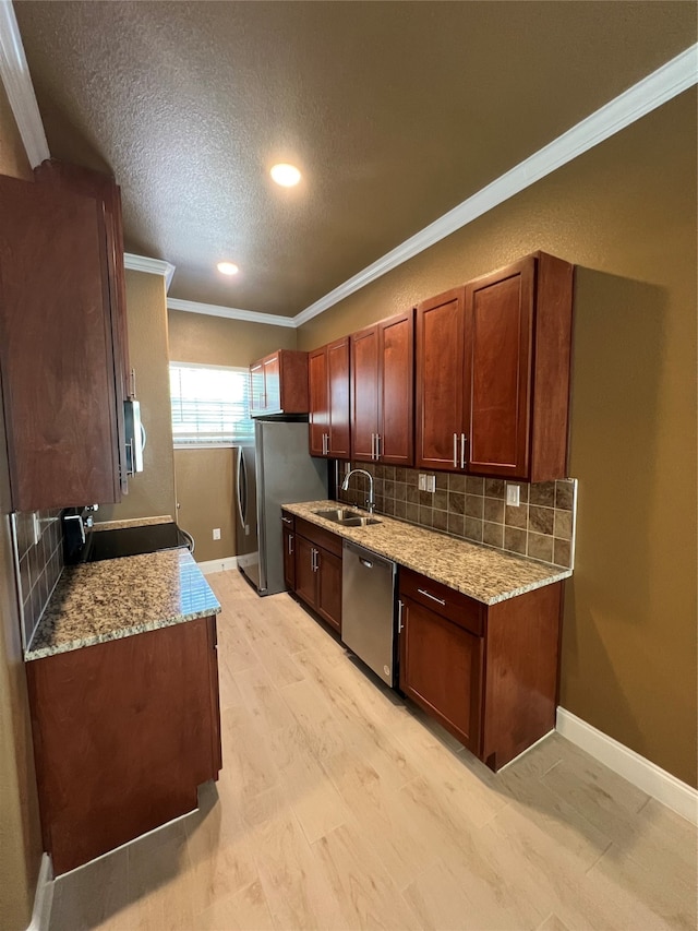 kitchen featuring light stone counters, a textured ceiling, appliances with stainless steel finishes, and decorative backsplash