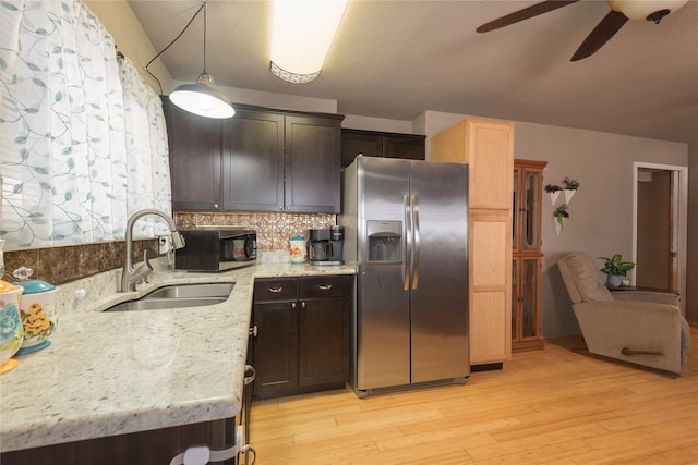 kitchen with sink, backsplash, stainless steel appliances, dark brown cabinetry, and light hardwood / wood-style floors