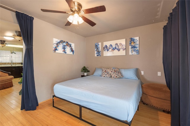 bedroom featuring light hardwood / wood-style flooring and ceiling fan