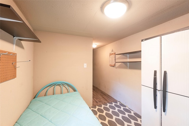 kitchen with a textured ceiling and light wood-type flooring