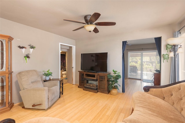 living room with ceiling fan and light wood-type flooring