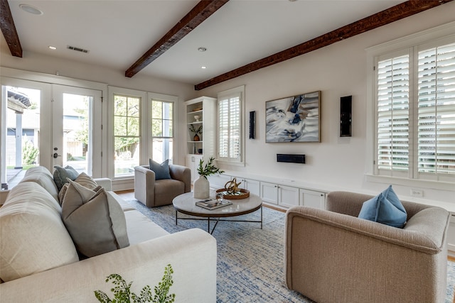 living room featuring french doors, beam ceiling, and a healthy amount of sunlight