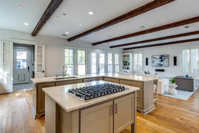 kitchen with a kitchen island, a healthy amount of sunlight, and sink