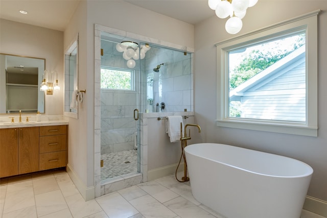 bathroom with vanity and shower with separate bathtub