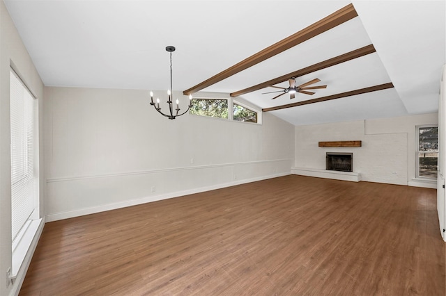 unfurnished living room featuring ceiling fan with notable chandelier, lofted ceiling with beams, and dark hardwood / wood-style floors