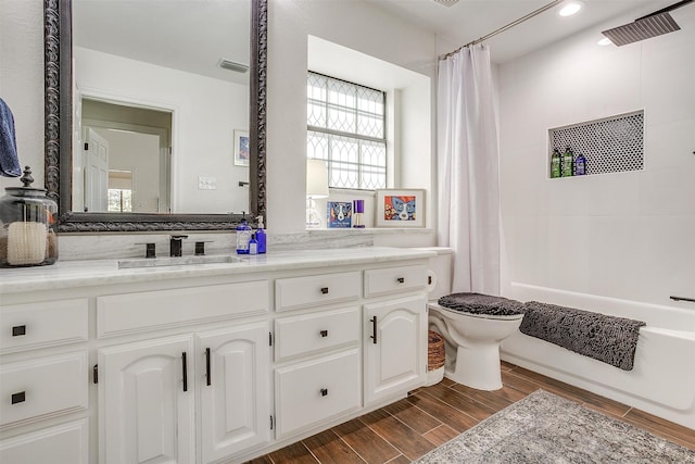 full bathroom with toilet, hardwood / wood-style flooring, vanity, and shower / bath combination with curtain