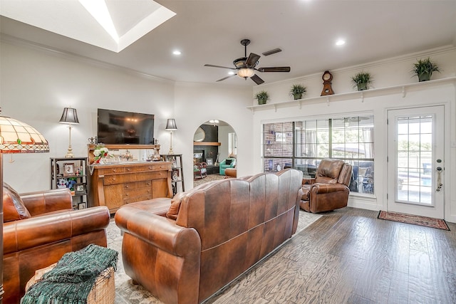 living room featuring ceiling fan, ornamental molding, and hardwood / wood-style floors