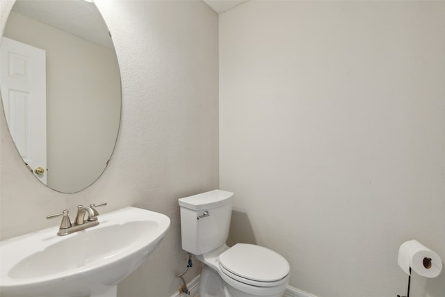 bathroom featuring toilet and sink