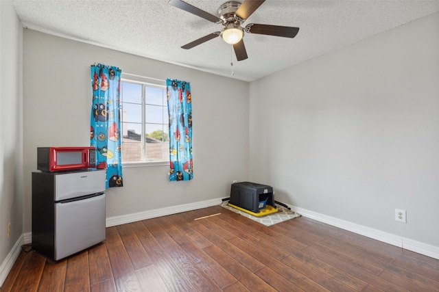 miscellaneous room with dark wood-type flooring, a textured ceiling, and ceiling fan