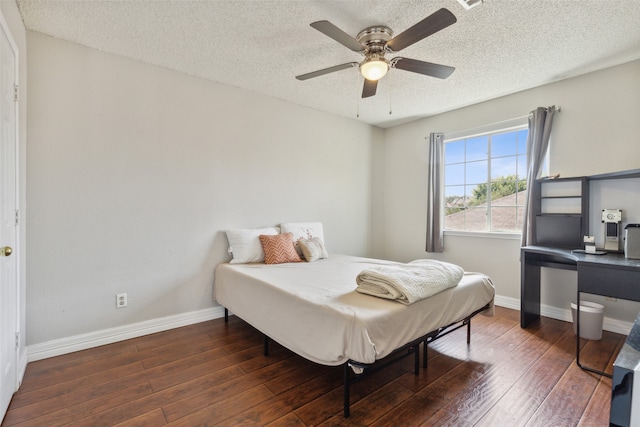 bedroom featuring ceiling fan, a textured ceiling, and dark hardwood / wood-style floors