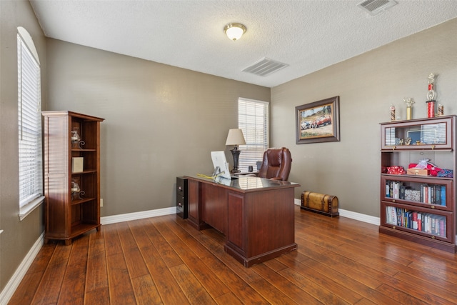 home office featuring a textured ceiling and dark hardwood / wood-style floors