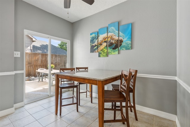 dining room with a textured ceiling, ceiling fan, and light tile patterned floors