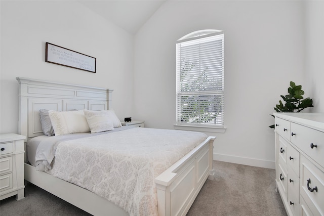 carpeted bedroom with lofted ceiling