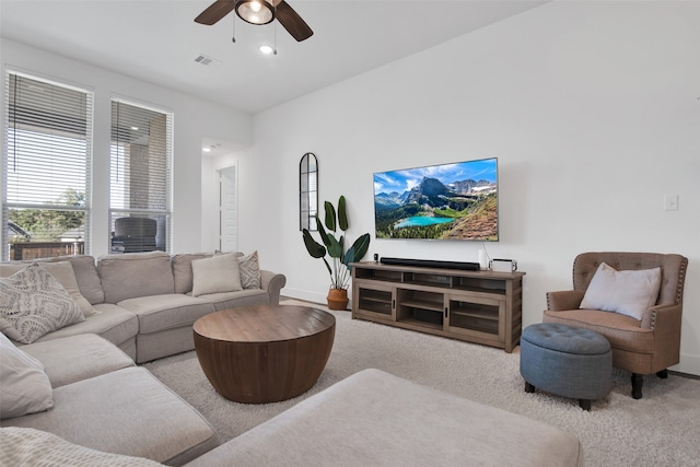 living room with light colored carpet and ceiling fan