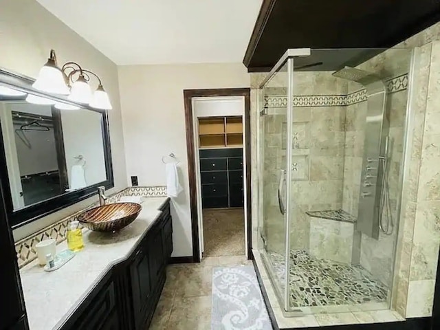 bathroom featuring an enclosed shower and vanity