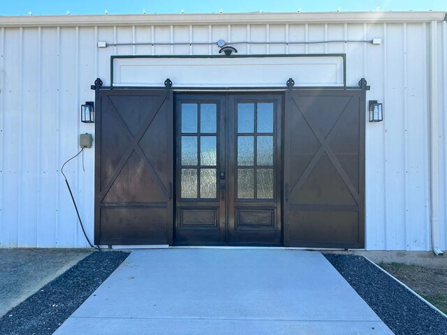 207 Emberson Chapel Rd, Pilot Point, TX 76258 - view of exterior entry with board and batten siding