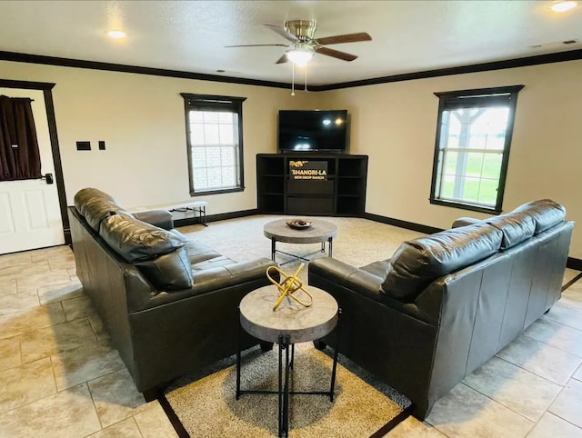 living room with ceiling fan, plenty of natural light, and crown molding