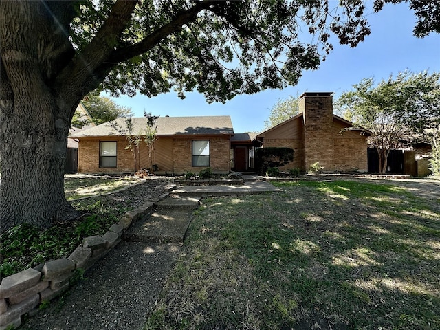 ranch-style house with a front lawn