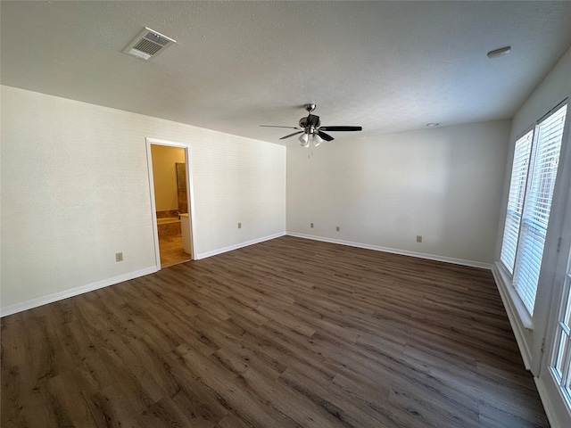 unfurnished room with ceiling fan and dark wood-type flooring