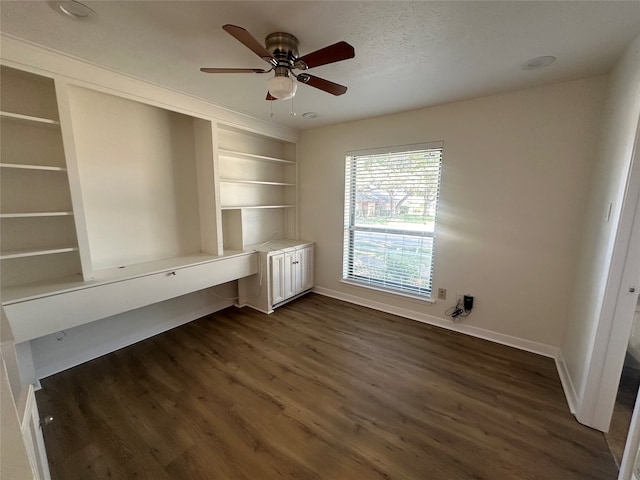 interior space featuring ceiling fan and dark wood-type flooring