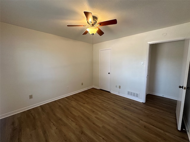 unfurnished bedroom with ceiling fan and dark hardwood / wood-style flooring